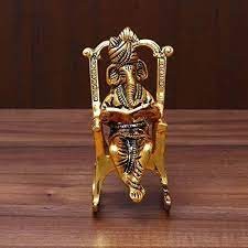 Lord Ganesha Statue Sitting on A Chair and Reading Ramayan